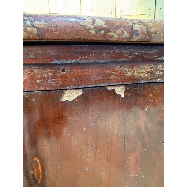 A napoleon iii period curved corner buffet in solid mahogany and flame mahogany veneer, with a characteristic bombé...