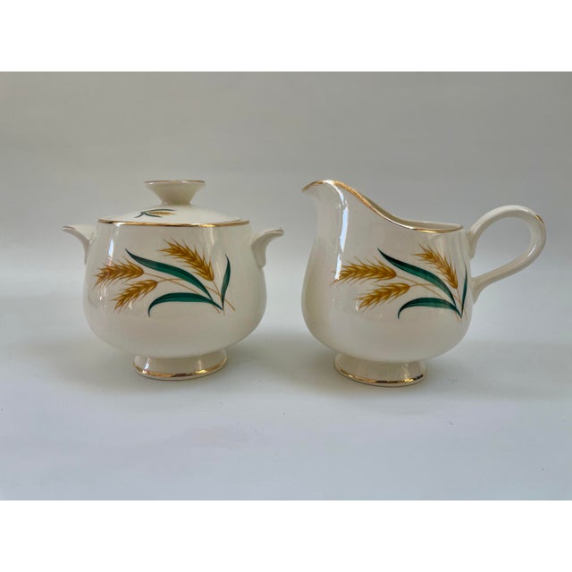 Midcentury gilt Royal Harvest Sugar and Creamer set both in excellent condition. Creamer, 4.75" L x 3.5" W x 4.25" H....