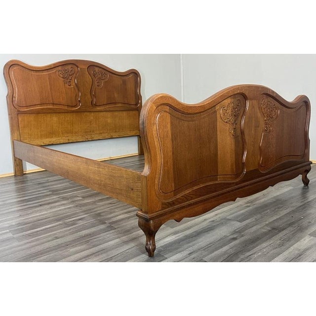 This elegant Vintage French Louis–style double bed frame showcases beautifully shaped oak panels with flowing curves and...