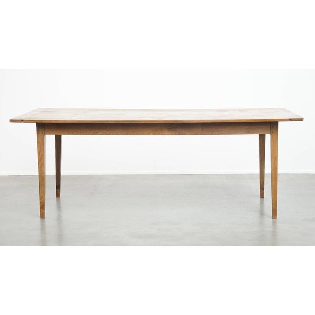 Offered this timeless and characterful antique French dining table for at least 6 people. A timeless addition to almost...