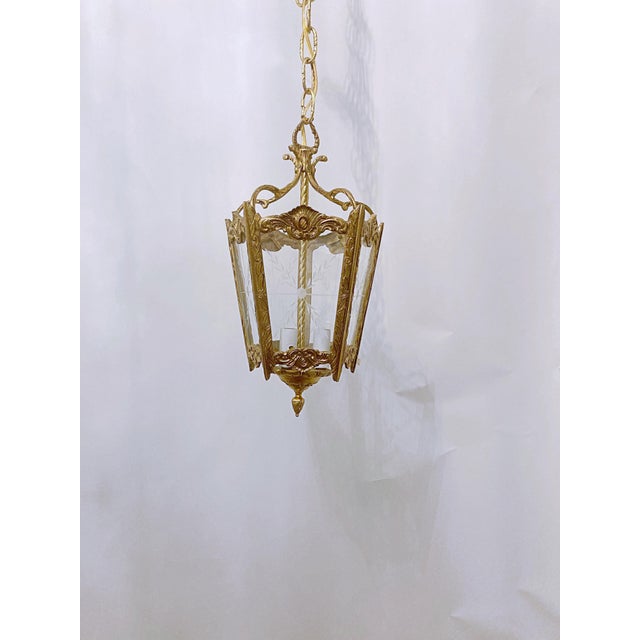 Bronze Lantern With Etched Glass Panels. It has 3 light with candelabra base sockets that each holds a 75W light bulbs or...