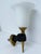 Striking and sculptural Nubian hand wall sconce by noted French artist John Devoluy, featuring a black left hand holding a...