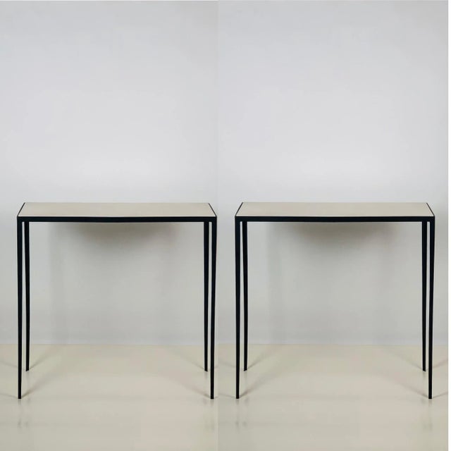 Contrasting grained cream parchment tops over slender blackened steel frames. Beautiful, simple, understated design....