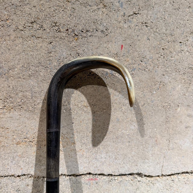 For your consideration, a 19th-century antique walking cane featuring a shaped horn handle and a stacked horn shaft. The...