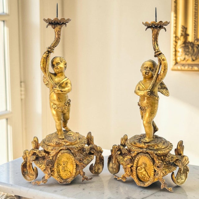 A finely executed pair of late 19th-century French gilt bronze figural candlesticks, conceived within the Rococo Revival...