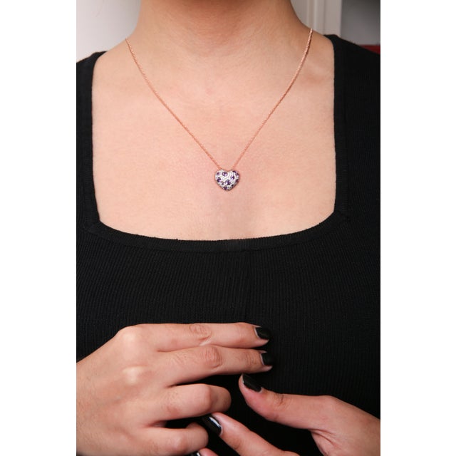 Let love and romance blossom in your life with this enchanting heart-shaped cluster pendant necklace made from genuine 18k...