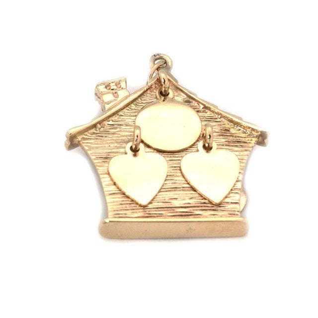 Crafted with a classic touch, this 14k yellow gold pendant showcases a charming house motif that exudes a warm and...