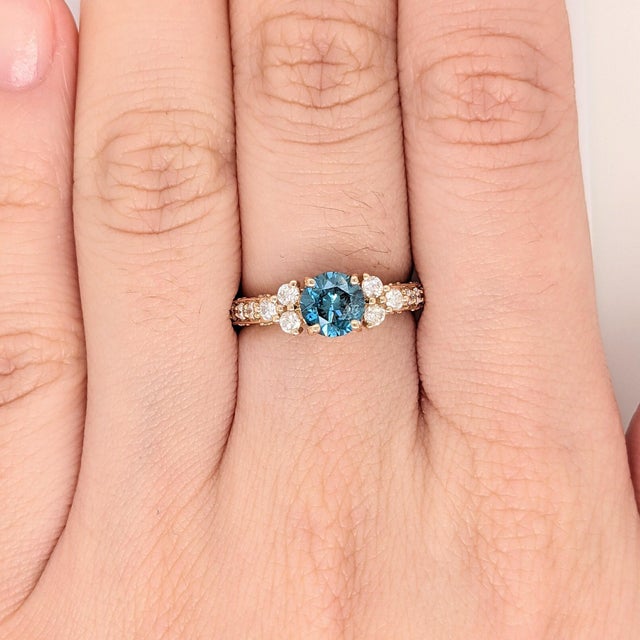 A rare blue diamond sits with a rare fancy blue at the centre of this solid 14K yellow gold ring. A fancy blue is among...