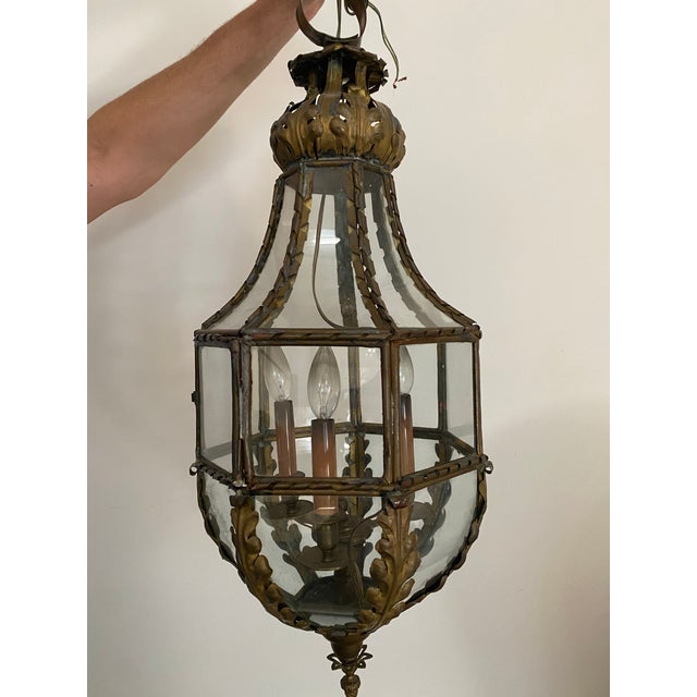 Beautiful vintage foliate lantern with leaf details and an acorn finial in an aged, patinated brass finish. Areas of...