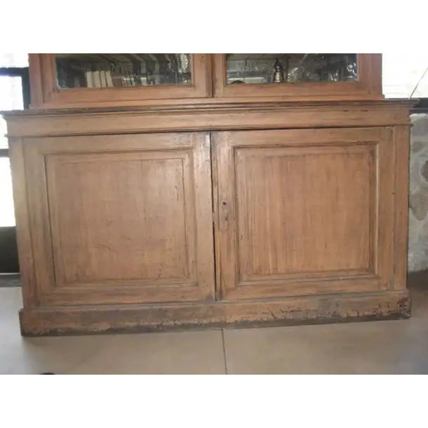 19th Century mirrored Vitrine or Bookcase with a great patina. The top cabinet has four adjustable shelves with two glass...
