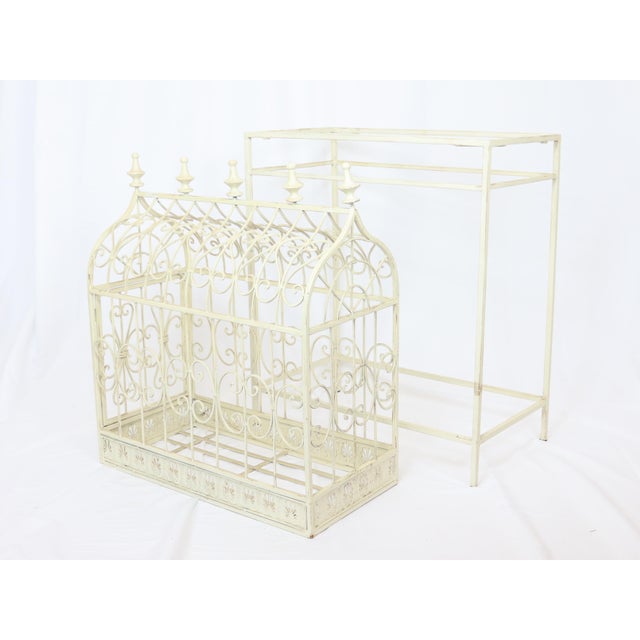 Vintage decorative bird cage with stand made of tubular metal. Fabulous scrolls and stately finials. Opens on the end for...