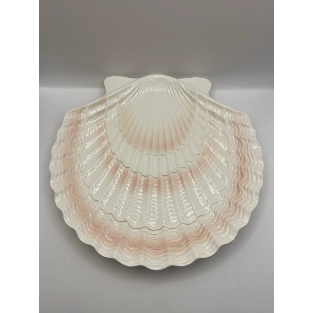 A textured scallop shaped plate in a warm tone color palette made by the Otagiri company.