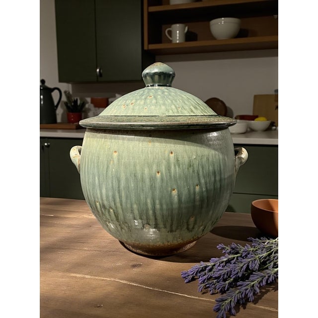Hand-thrown stoneware lidded pot in a soft celadon/green drip glaze made by Brad Tucker, from the Cedar Creek Pottery in...