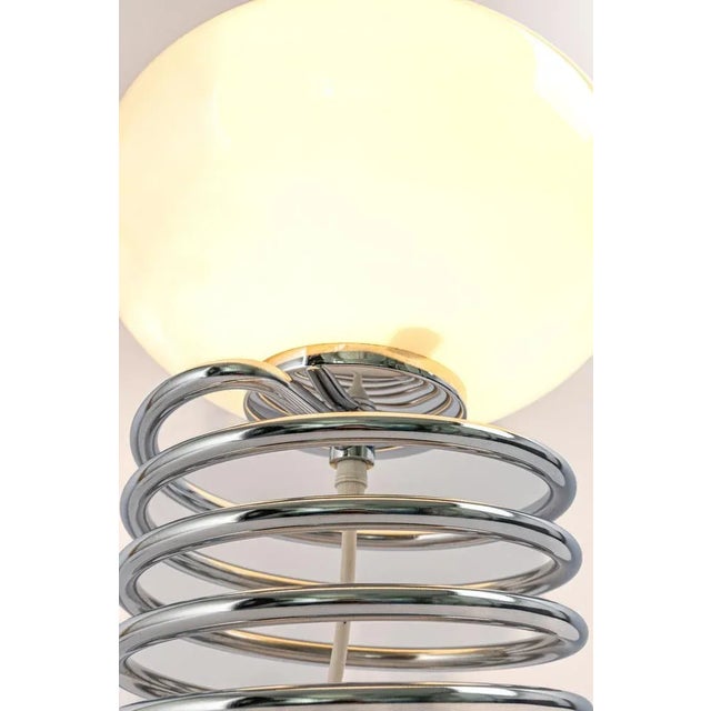Wonderful spiral table lamp in the style of designer ingo maurer, germany, 1970s. Great shape with a white glass shade on...