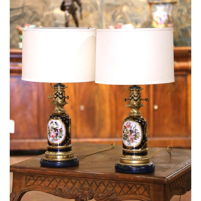 Elegant and richly decorated, this pair of antique French Napoleon III lamps was originally made as oil lamps and later...