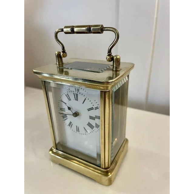 Antique Victorian quality brass carriage clock having a bevelled edge, glass panels, white enamel dial with Roman...