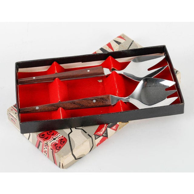 1960s cutlery sets. Two pieces of 1960s cutlery in a metal and wood box, perfect for a baby. H: 1.5cm, W: 16cm, D: 9cm.