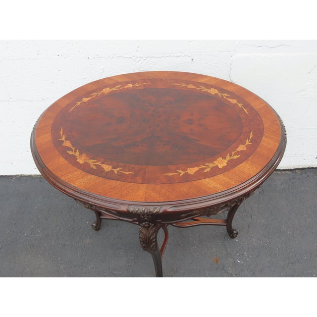 This elegant Center Table is made out of wood, solid wood, walnut, flame veneer, and veneer. The Table has French style...