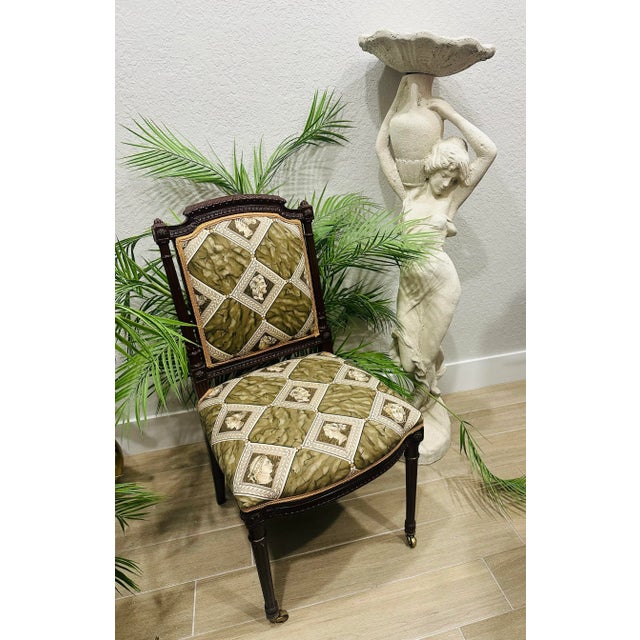 A exquisite pair of Louis XVI accent Chairs newly upholstered in a beautiful olive green with a gold border, the chairs...