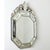 A dazzling Venetian-style octagonal mirror from the 19th century that projects from the wall like cushion mirrors of the...