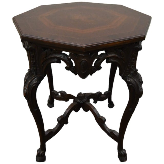 The Antique Carved Octagonal Burl Center Side Table, crafted in the Italian Renaissance style, features solid wood with a...