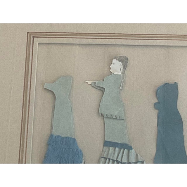 Sweet mid 19th C home made paper dolls framed in marbleized frame with French mat. Dolls are antique in contemporary framing.