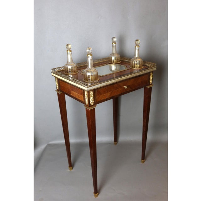 An elegant and rare louis xvi style marquetry wood salon table from the napoleon iii period. This table is unique in that...