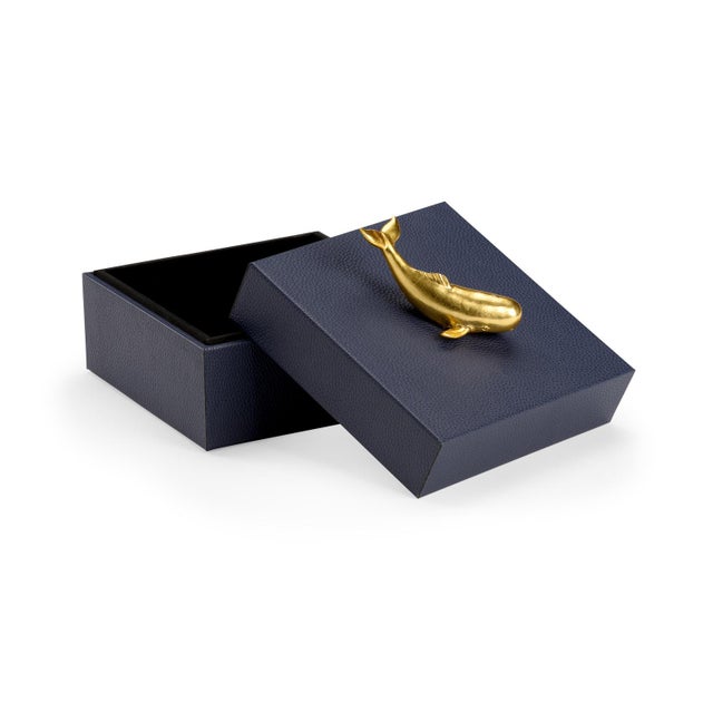 Felt Lined Wooden Box Covered In Navy Faux Leather With A Metallic Gold Whale Accent. Clean with a dry cloth