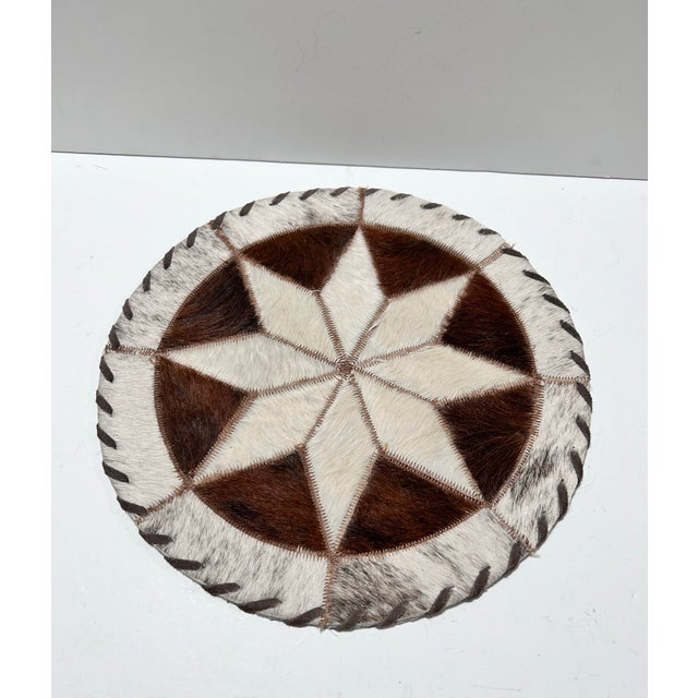 Handcrafted vintage round trivet or placemat made from genuine cowhide leather. The patchwork design forms an eye-catching...