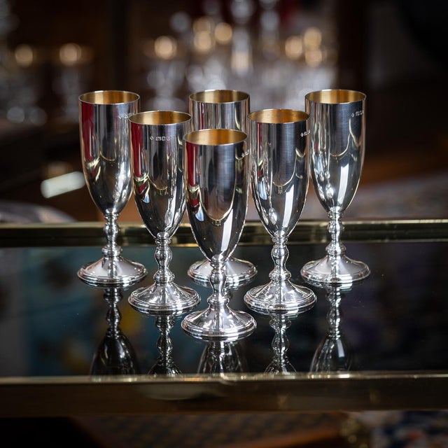 A vintage 20th century english solid silver set of six champagne flutes, masterfully crafted in an elegant silhouette....