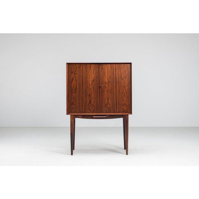 A rare bar cabinet designed by Illum Wikkelsø and produced by C.F. Christensen in Denmark during the 1960s. Crafted in...
