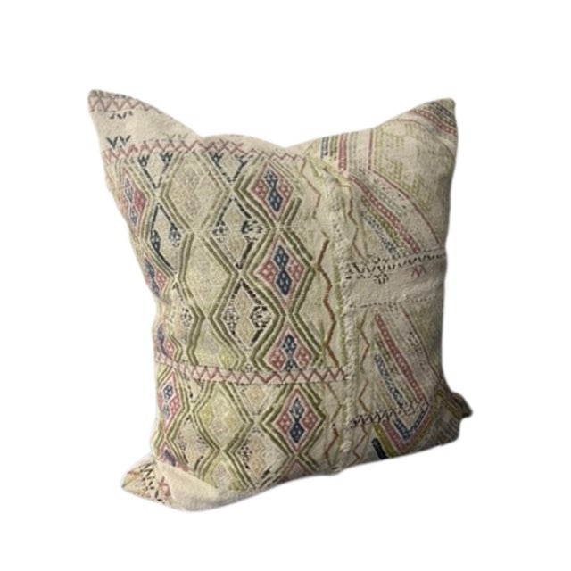 Intentionally distressed threads in geometric diamond pattern in pinks, greens, blues on beige cloth ground. Reverse side...