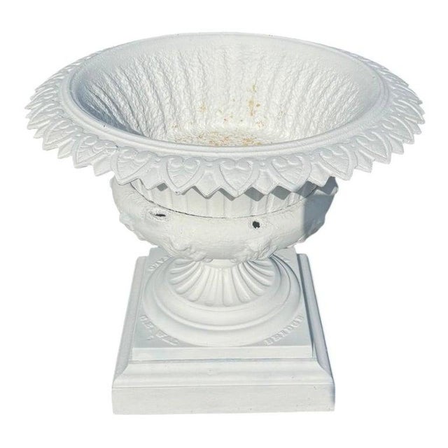 This antique classical garden urn is crafted from cast iron, featuring a robust and ornate design typical of the early...