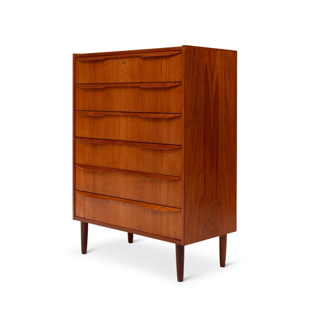 A masterful example of Danish Mid-Century Modern design, this 1960s teak tallboy dresser embodies the harmony of form,...