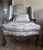 An exquisite pair of French Regency (1715-1723) walnut bergere armchairs, hand-carved and richly detailed. Crafted in...