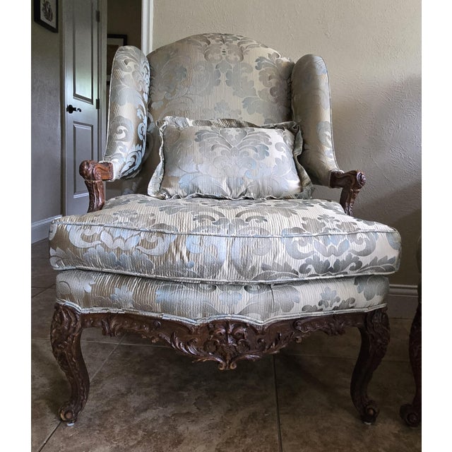 An exquisite pair of French Regency (1715-1723) walnut bergere armchairs, hand-carved and richly detailed. Crafted in...