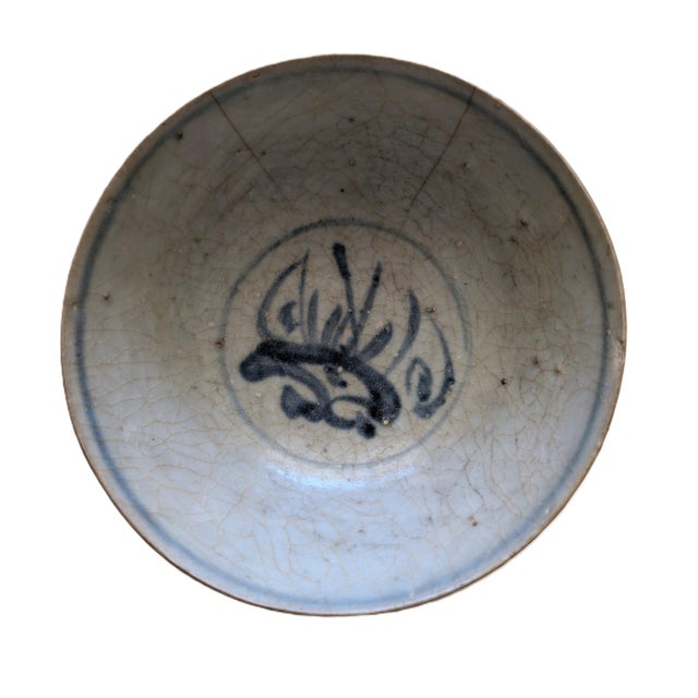 This late Ming blue-and-white bowl has a unique pattern: a dragon on one side, a phoenix on the other, and a hornless...
