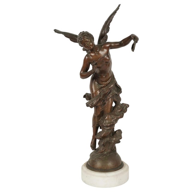 A finely cast patinated bronze sculpture depicting a graceful winged female figure in flowing drapery, poised in motion,...