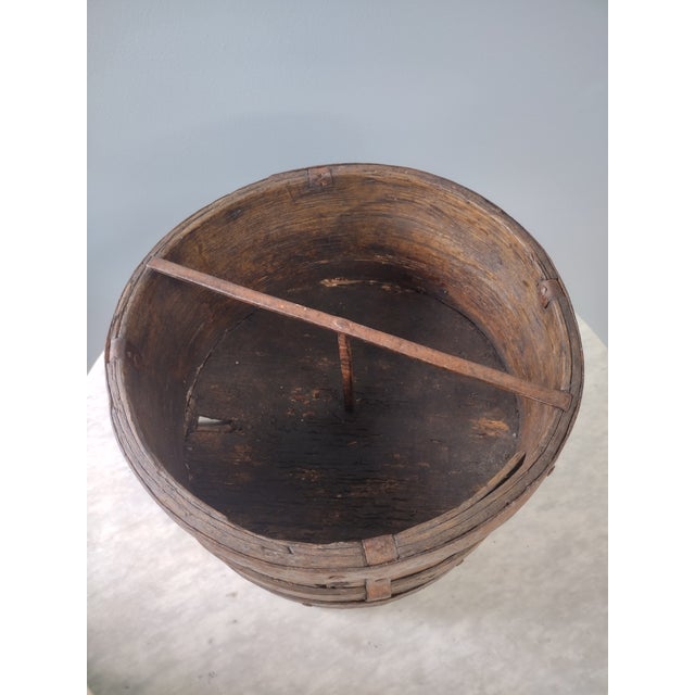 Antique measure for grain or dry goods, dating from the 1800s or earlier. This bentwood and iron measure would look...