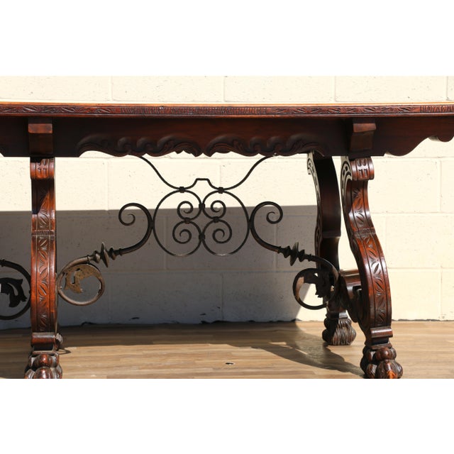 Impressive Spanish Baroque Revival trestle dining table, circa 1970s, crafted from a combination of rosewood and walnut...