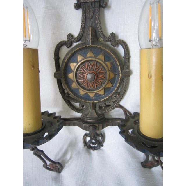 Iron two arm sconce that holds single bulb in each. Ready to be hard wired into the wall. Wiring is in good working order....