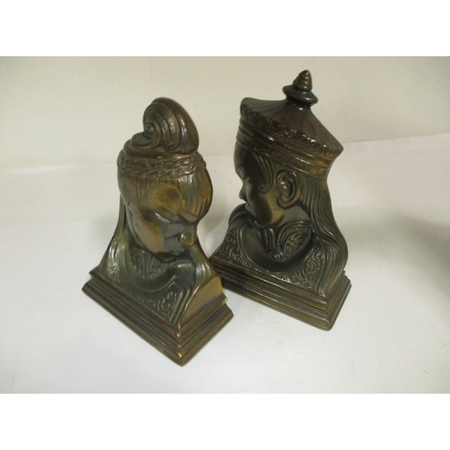 Vintage 1940's pair of emperor and emperies Asian style bookends. They have an antique brass finish and sculpted details....