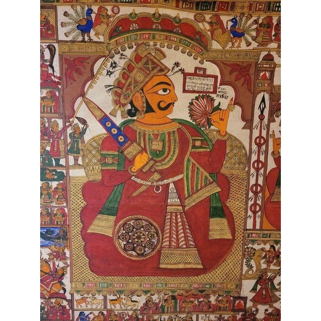 This large hand-drawn and hand-painted Rajasthani scroll painting ( called a phad or par) tells the story of Pabuji, a...