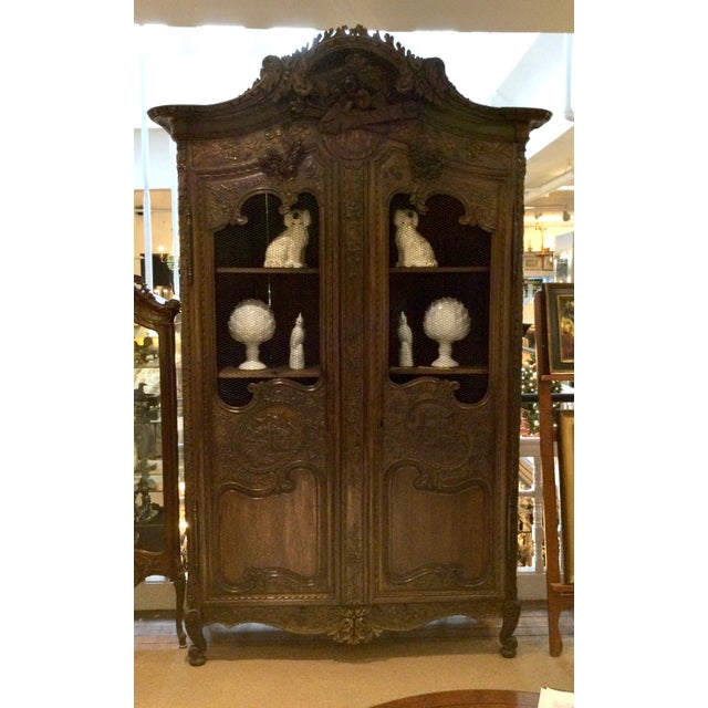 Beautiful highly carved wedding armoire of oak and mesh. In good age appropriate condition. Has key and shelves....