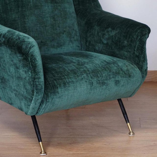 A pair of mid-century lounge chairs. Original brass capped feet with green fabric re-upholstery. Attributed to gigi radice...