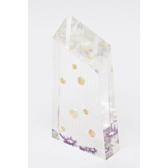 This vintage 1970's lucite embedded object sculpture is signed but not legible. It has purple dried flowers and circular...