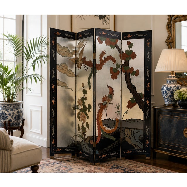 A striking vintage four-panel Chinoiserie folding screen featuring an elaborate landscape of phoenixes, flowering foliage,...