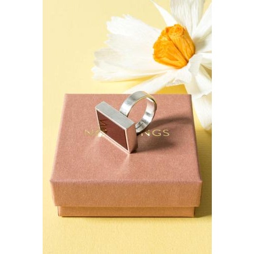 Cool silver ring by Elis Kauppi, in a crips rectangular design where a deep red carnelian stone is elegantly framed by...