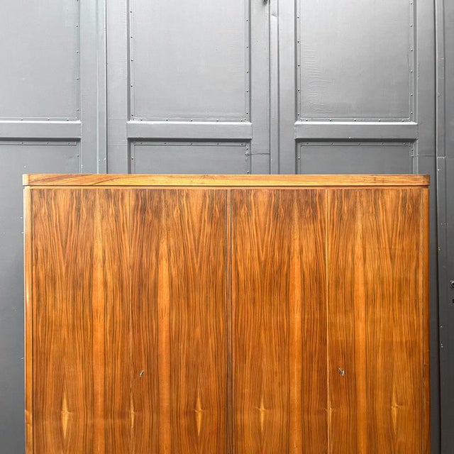 Product: wardrobe style: mid-century · 1960s material: walnut veneer · with mirrored veneer pattern features: four doors ·...