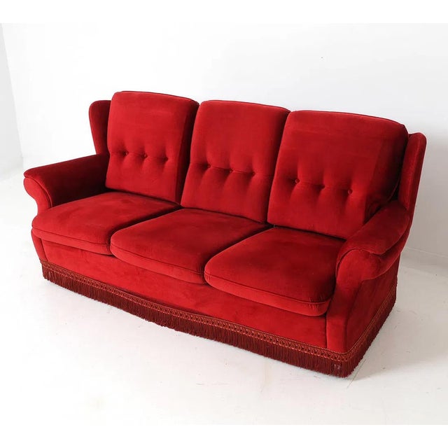 A gorgeous plush red Danish modern sofa with removable cushions. Soft, ribbed, velvety upholstery material. Fringed bottom...